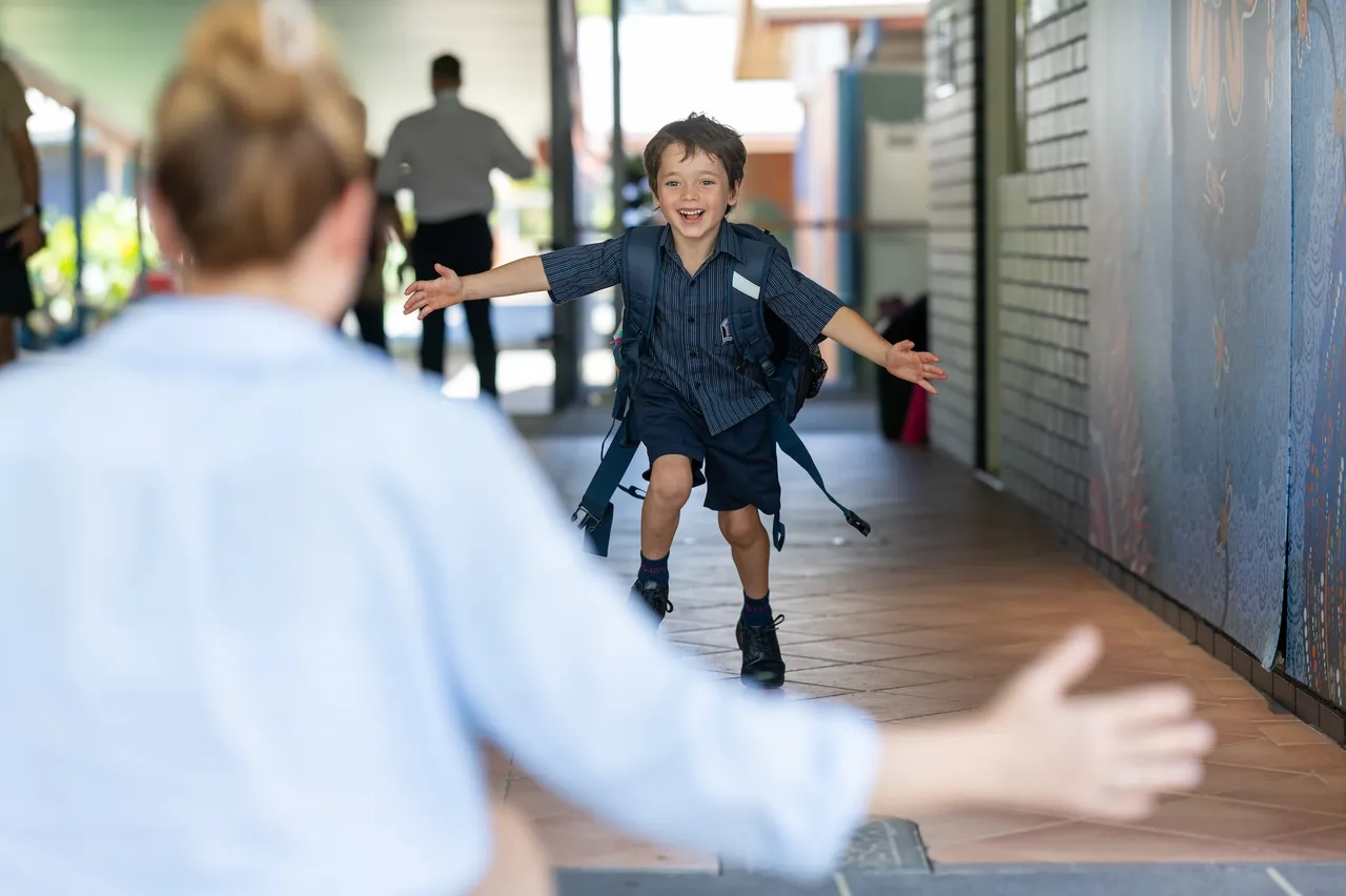 Kindergarten students smiling in classroom at Bishop Druitt College, Coffs Harbour