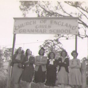 Students standing under the school signage in 1946
