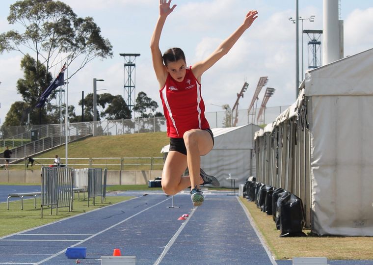 High school sport student in long jump.