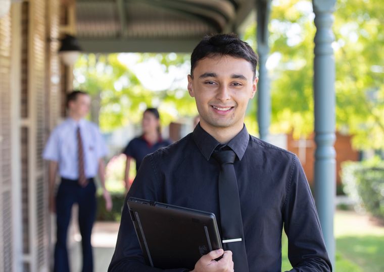 Teacher smiling at camera.