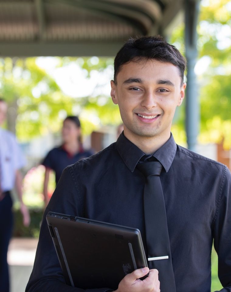 Teacher smiling at camera.