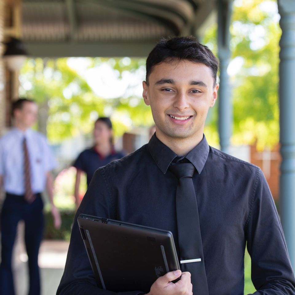 Teacher smiling at camera.