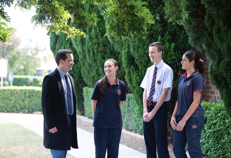 High school students talking to school principal.