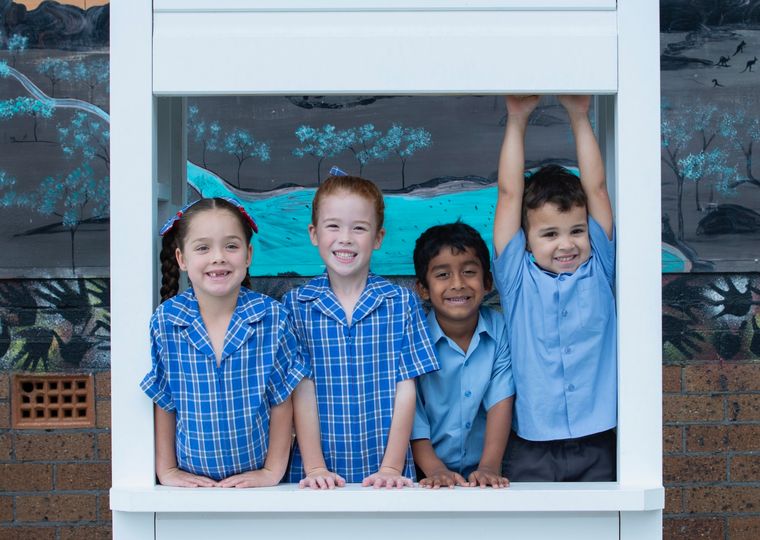 Primary school students in white booth.