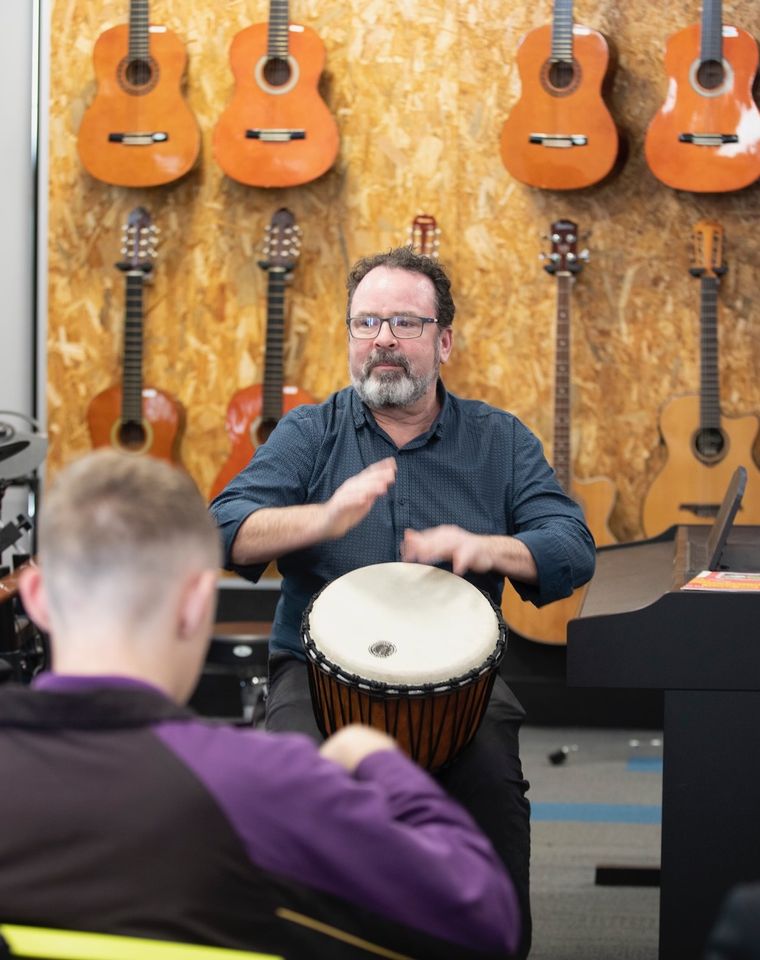 High school teacher playing drums.