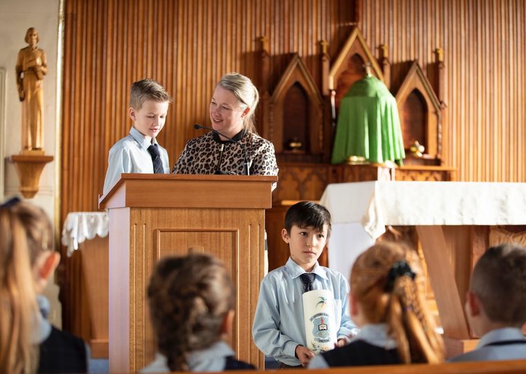 Primary school students with teacher at church.