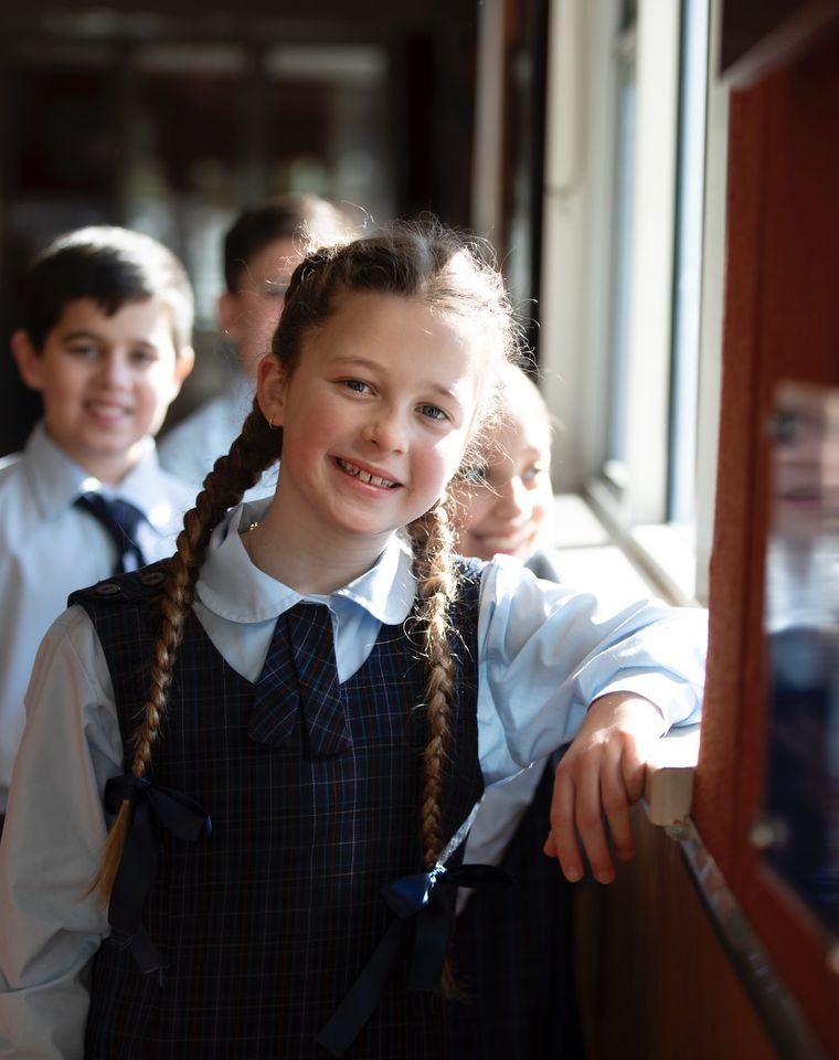 Primary school student smiling at camera.