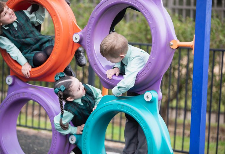 Primary school students with outdoor play equipment.