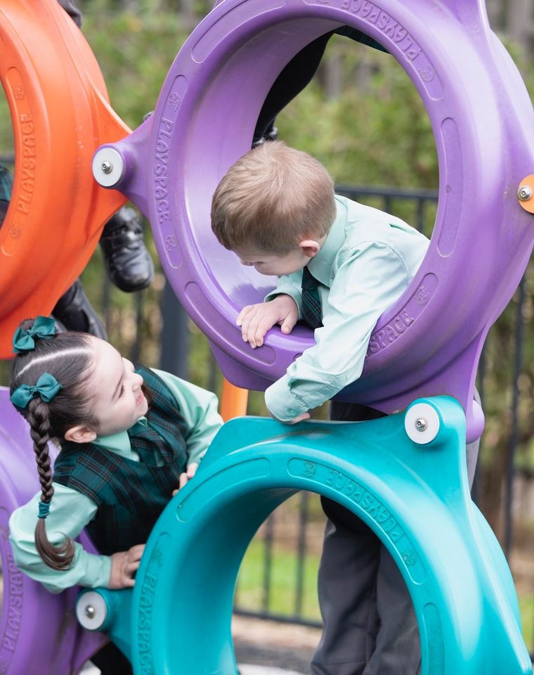 Primary school students with outdoor play equipment.