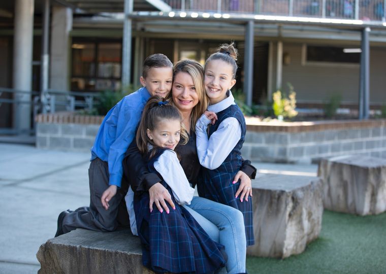 Three primary school students with parent.