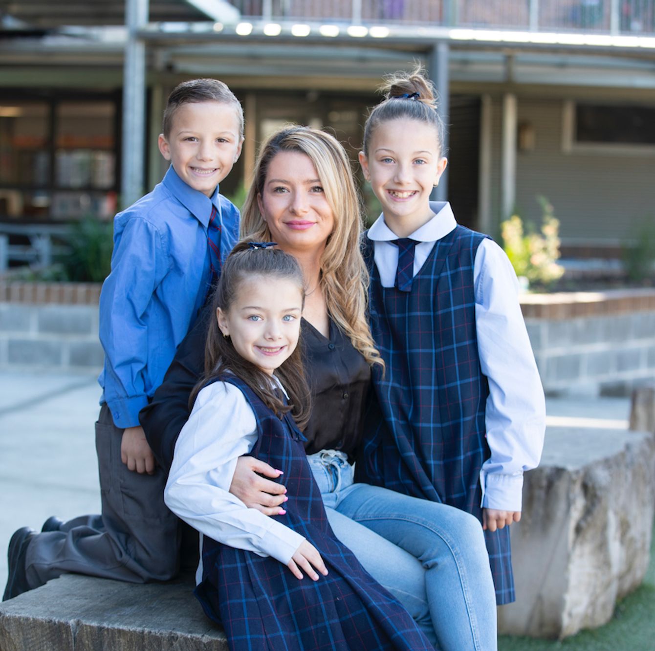 Three primary school students with parent.