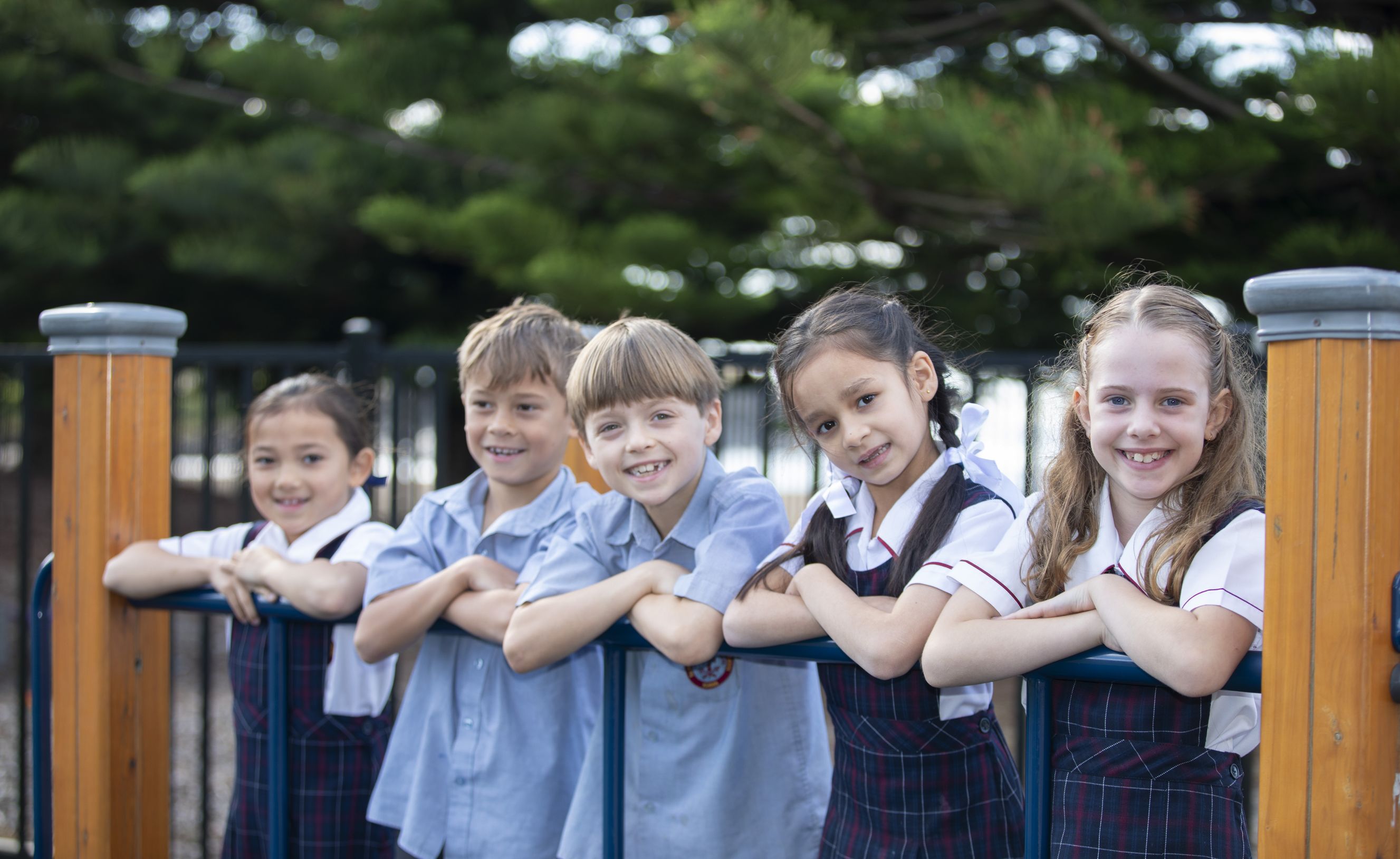 Primary school students on playground equipment.