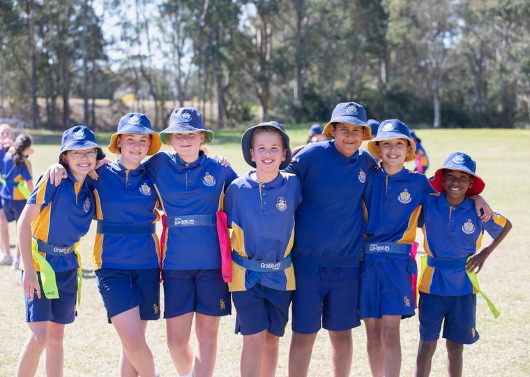 Group of primary school students standing together in sports uniform.