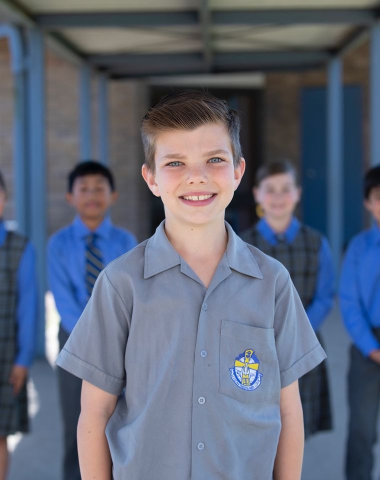 Primary school student smiling at camera.