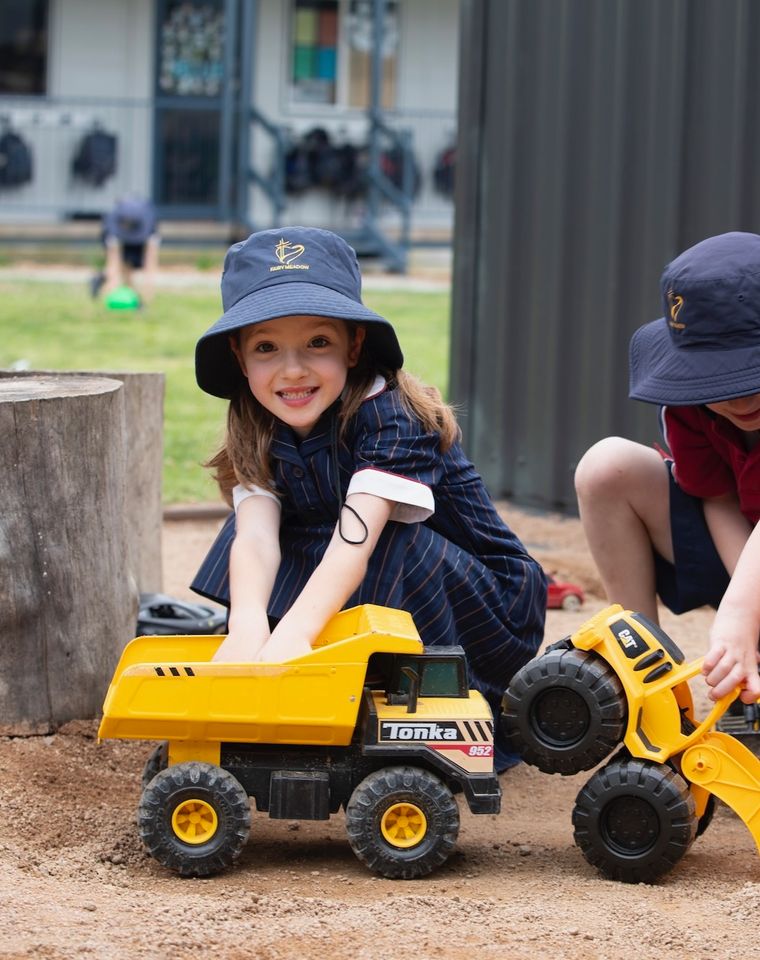 Primary school students playing in sandpit.