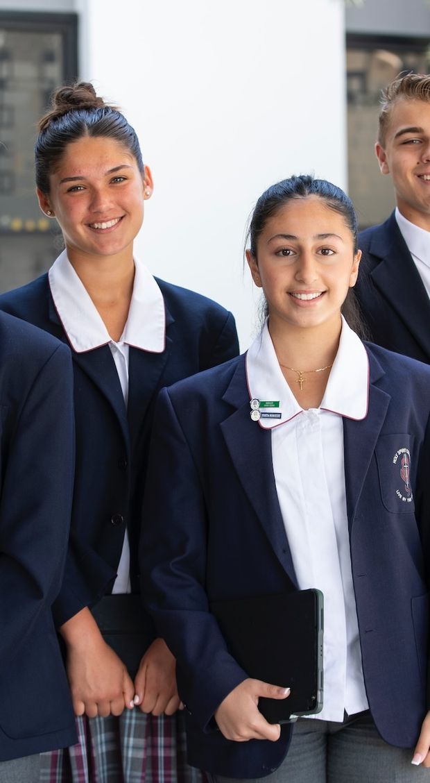 High school students standing in uniform.