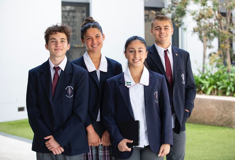 High school students standing in uniform.