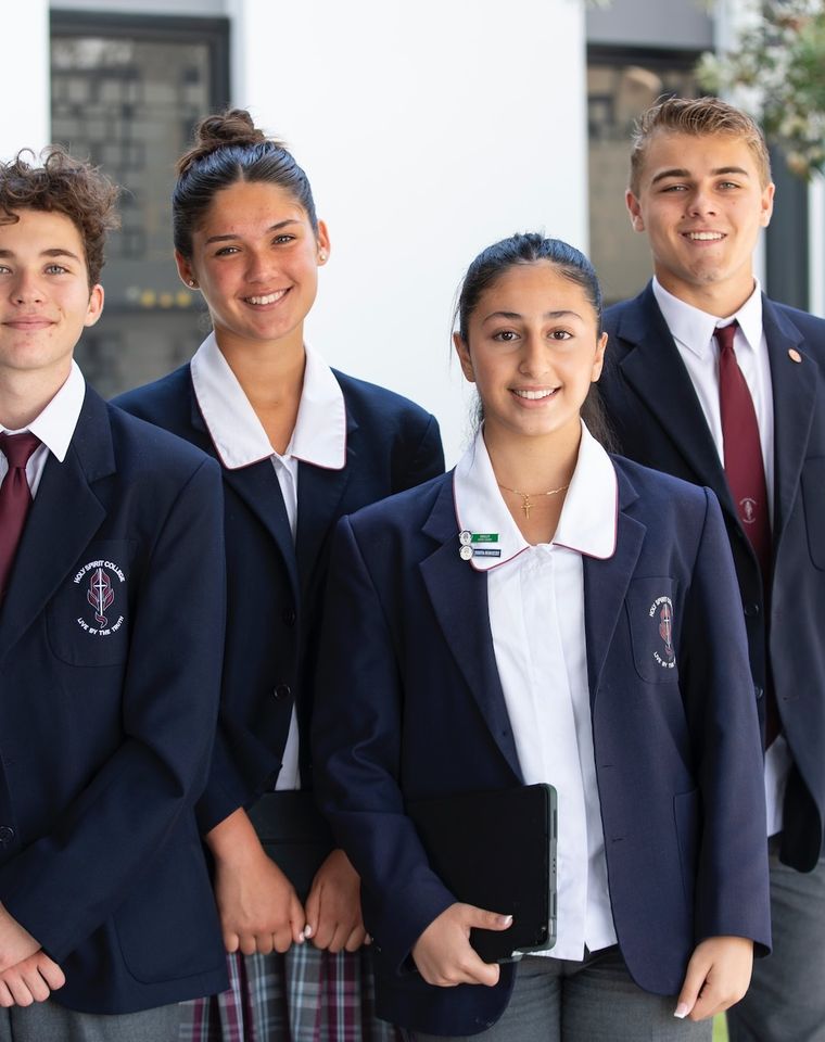 High school students standing in uniform.