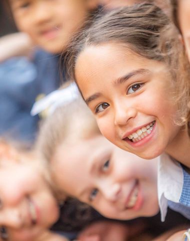 A group of Junior School students at Ruyton Girls' School smiling at the camera