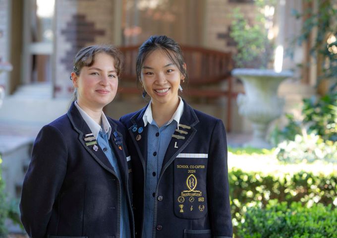 The two 2024 School Co-Captains standing in the garden, outside the historic Henty House.