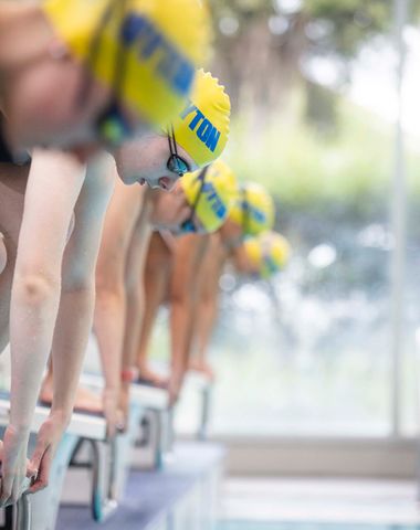 Ruyton Swimmers in position on the starting block, ready to dive into the pool.