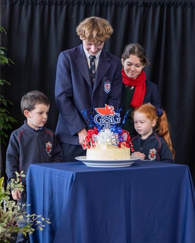 Cutting of the Foundation Day cake by the schools youngest and oldest students.