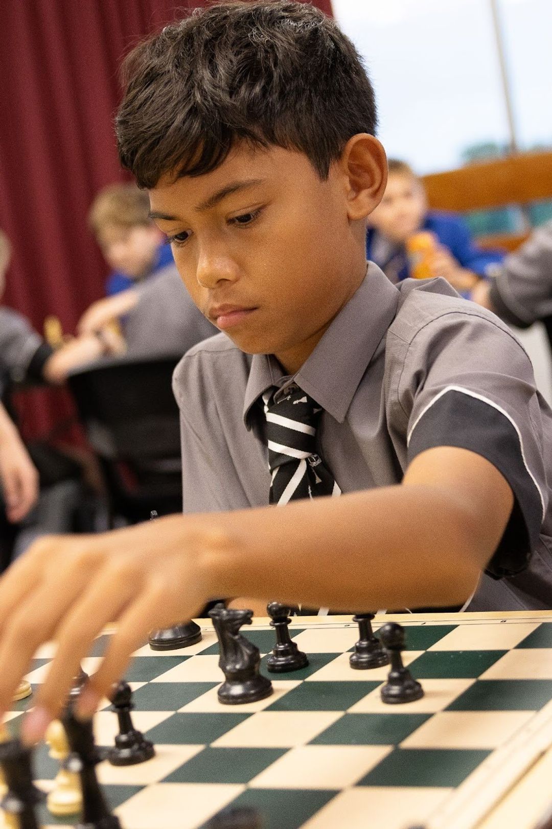 Student contemplates his next move in chess