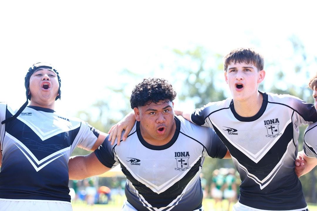Close up of Iona rugby team in a huddle chanting