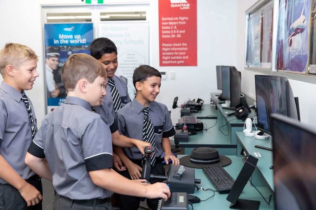 A group of students excitedly using a computer