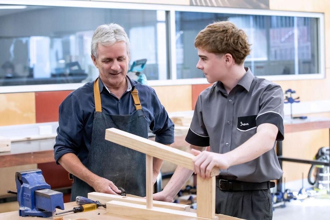 A teacher and student working together in the woodwork room