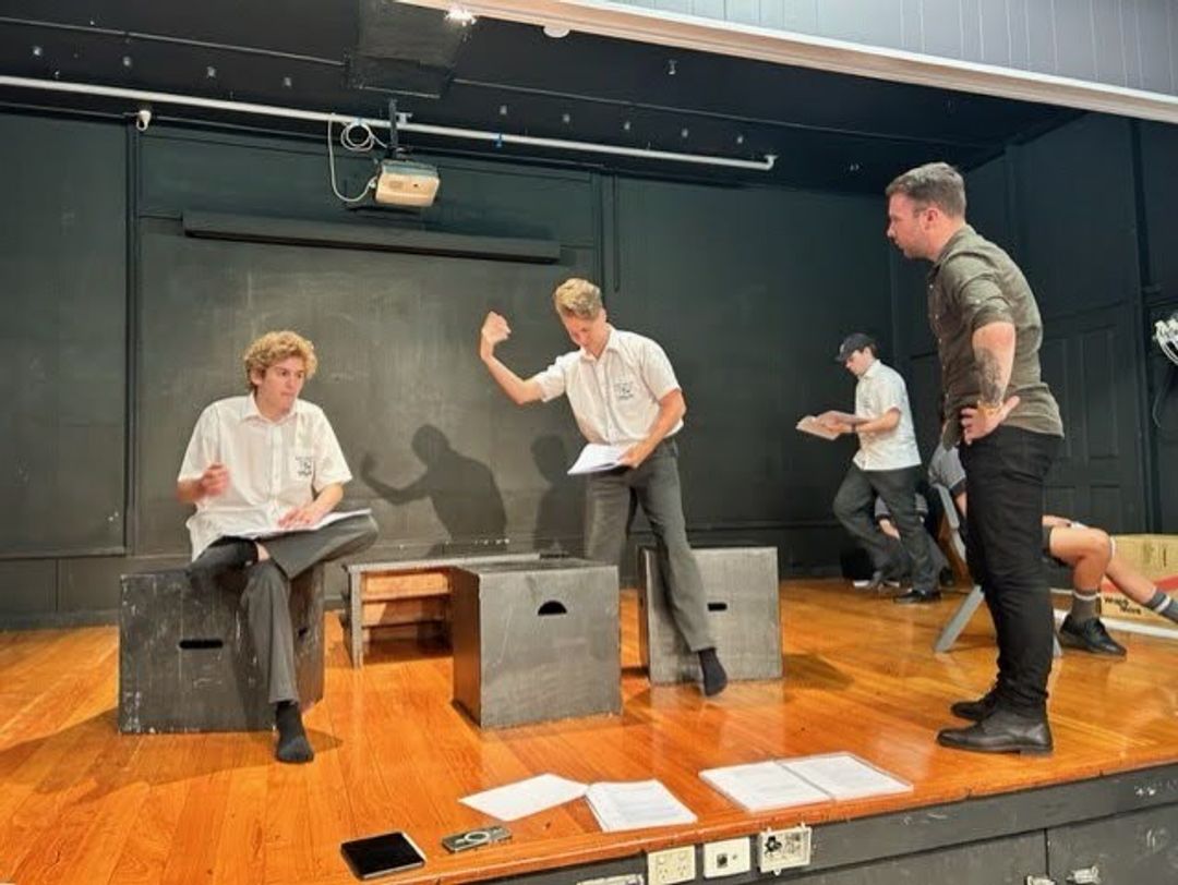 A group of students practicing a show on stage