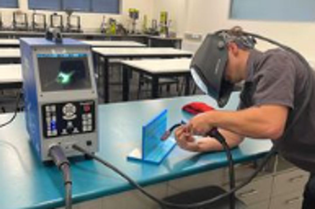 Student using a soldering iron