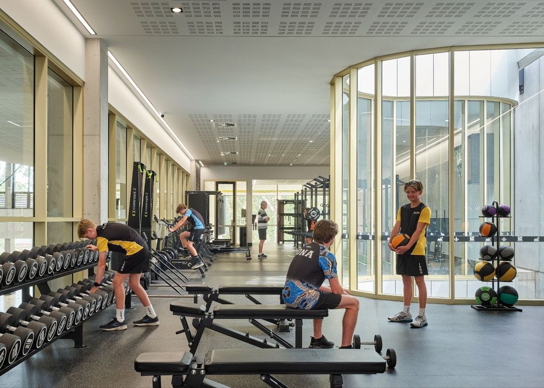 Students using the weights section of the gym