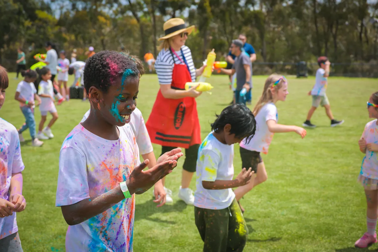 Primary school-aged children participating in the Overnewton bi annual Parents and Friends Association fundraising Colour Fun Run held at Canowindra Campus Oval, Taylors Lakes.