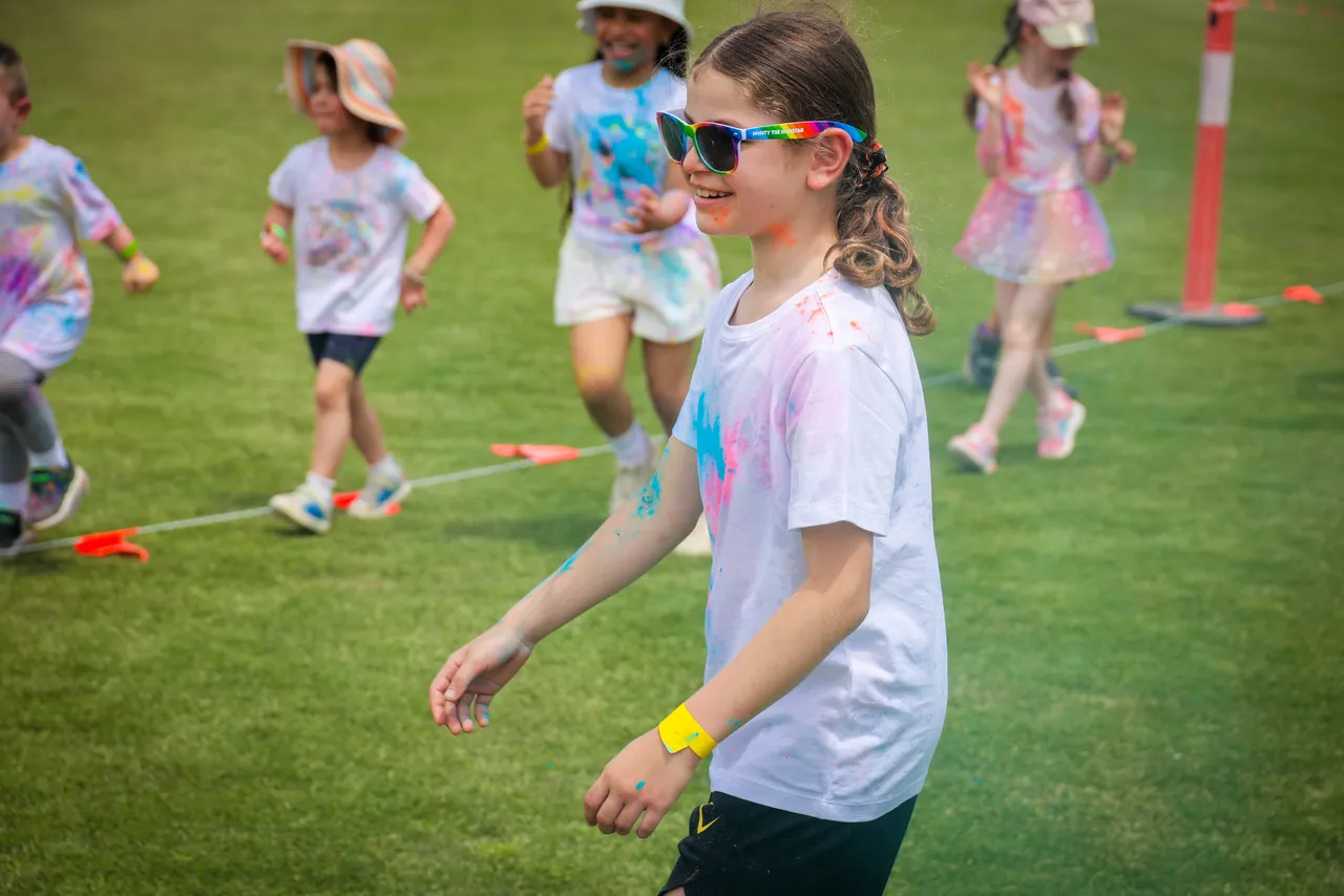 Primary school-aged children participating in the Overnewton bi annual Parents and Friends Association fundraising Colour Fun Run held at Canowindra Campus Oval, Taylors Lakes.