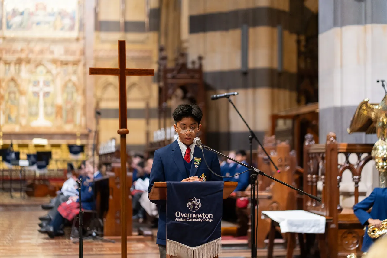 A lower-secondary school aged student from the Middle School speaking at a pulpit in St Paul's Cathedral, Melbourne, participating in Overnewton Anglican Community College's Founders' Day Service in June 2025.