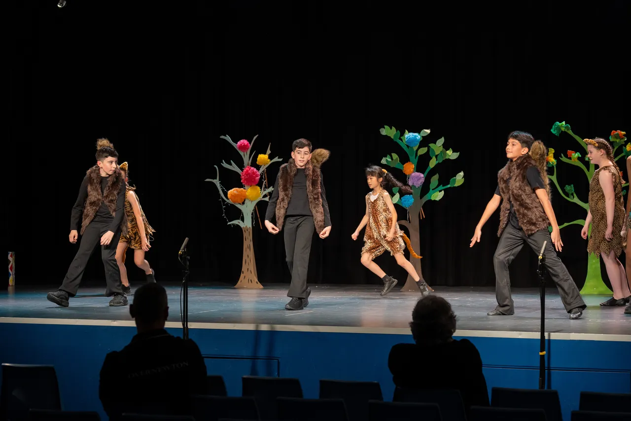 A group of upper primary school aged students performing on stage as part of the cast of the Middle School Year 5 & 6 Musical Season 1 production of Seussical KIDS.