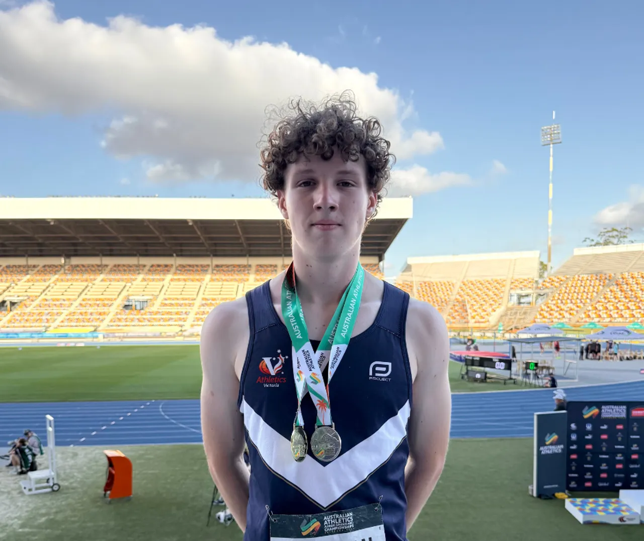 Upper secondary school aged Year 10 student and National Athletics Champion, Owen, proudly displaying his gold and silver medals after wins at the 2026 Australian Athletics Junior Championships.