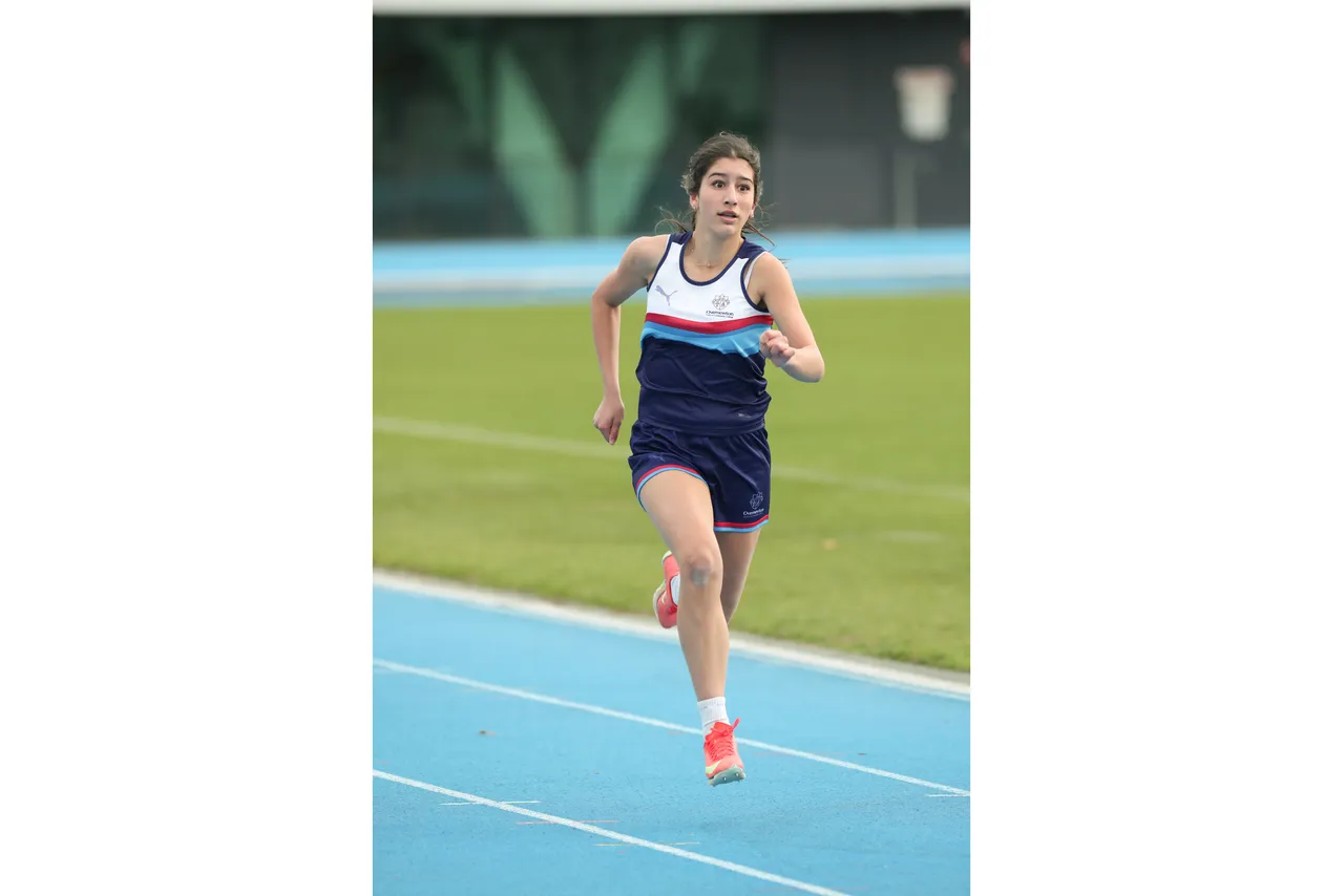 Action shot of upper secondary school aged student competing in the long distance running event at the 2026 ACS Athletics Championship.