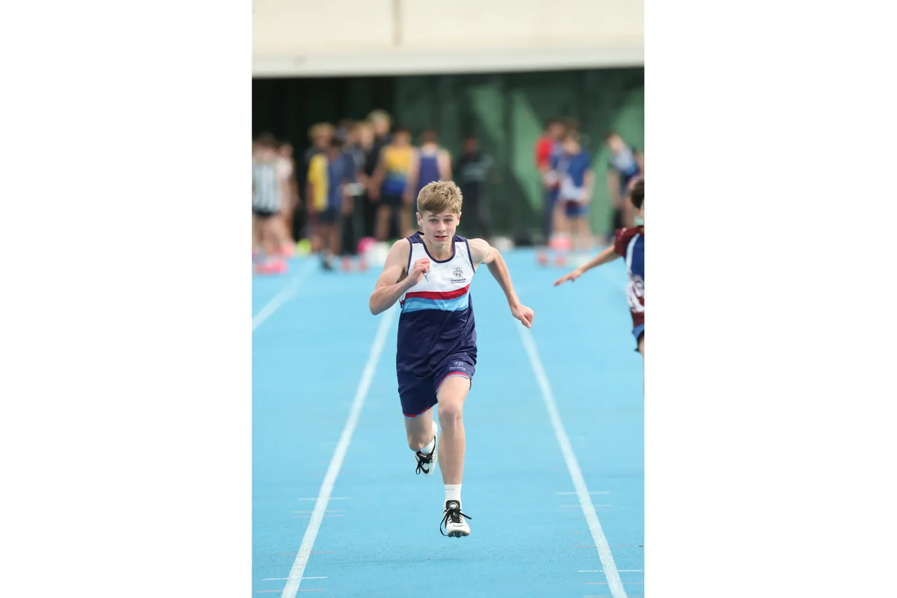 Action shot of upper secondary school aged student competing in the sprint event at the 2026 ACS Athletics Championship.
