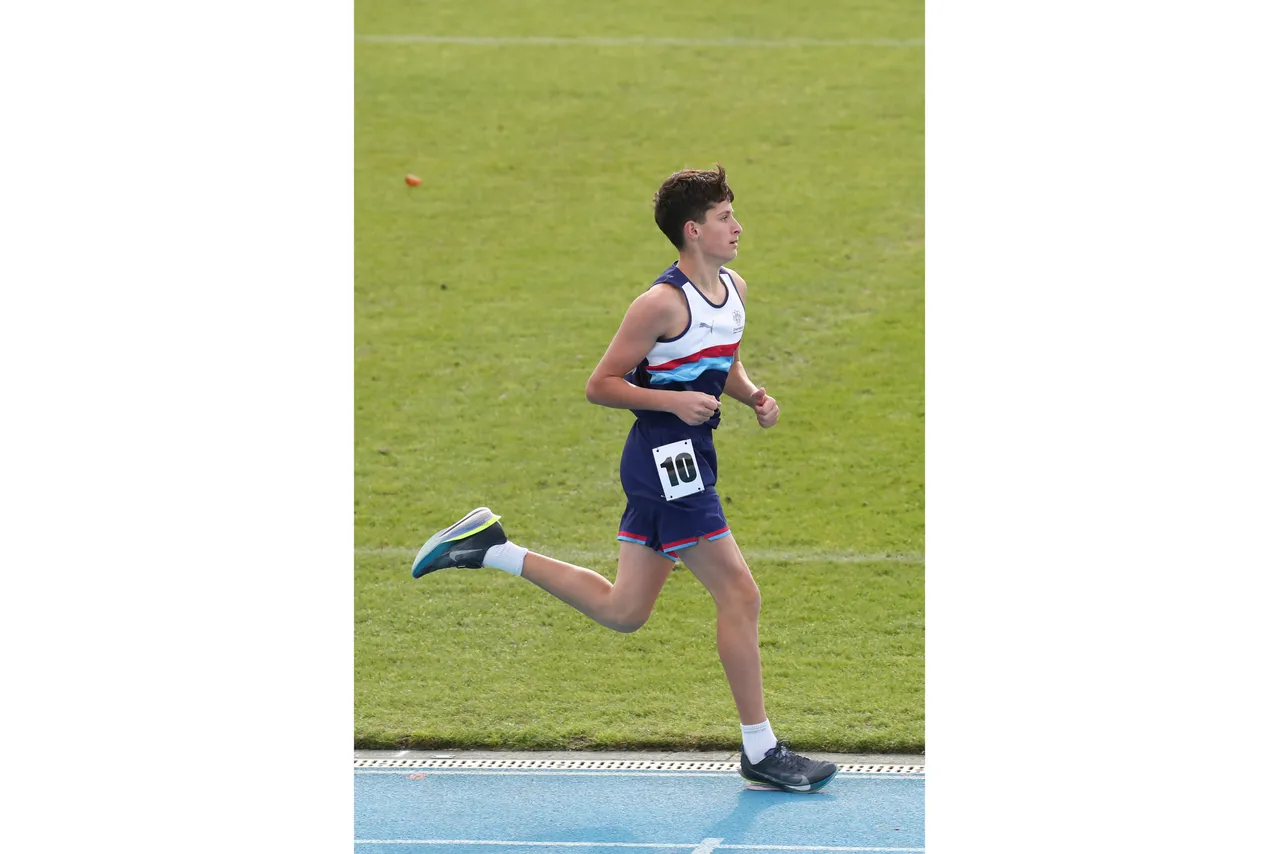 Action shot of upper secondary school aged student competing in the long distance running event at the 2026 ACS Athletics Championship.