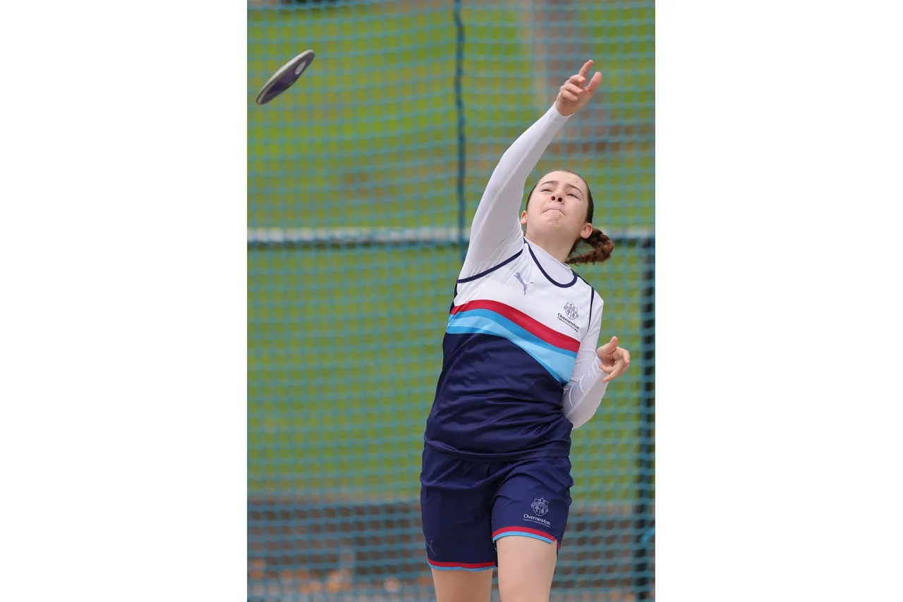 Action shot of upper secondary school aged student competing in the discus event at the 2026 ACS Athletics Championship.