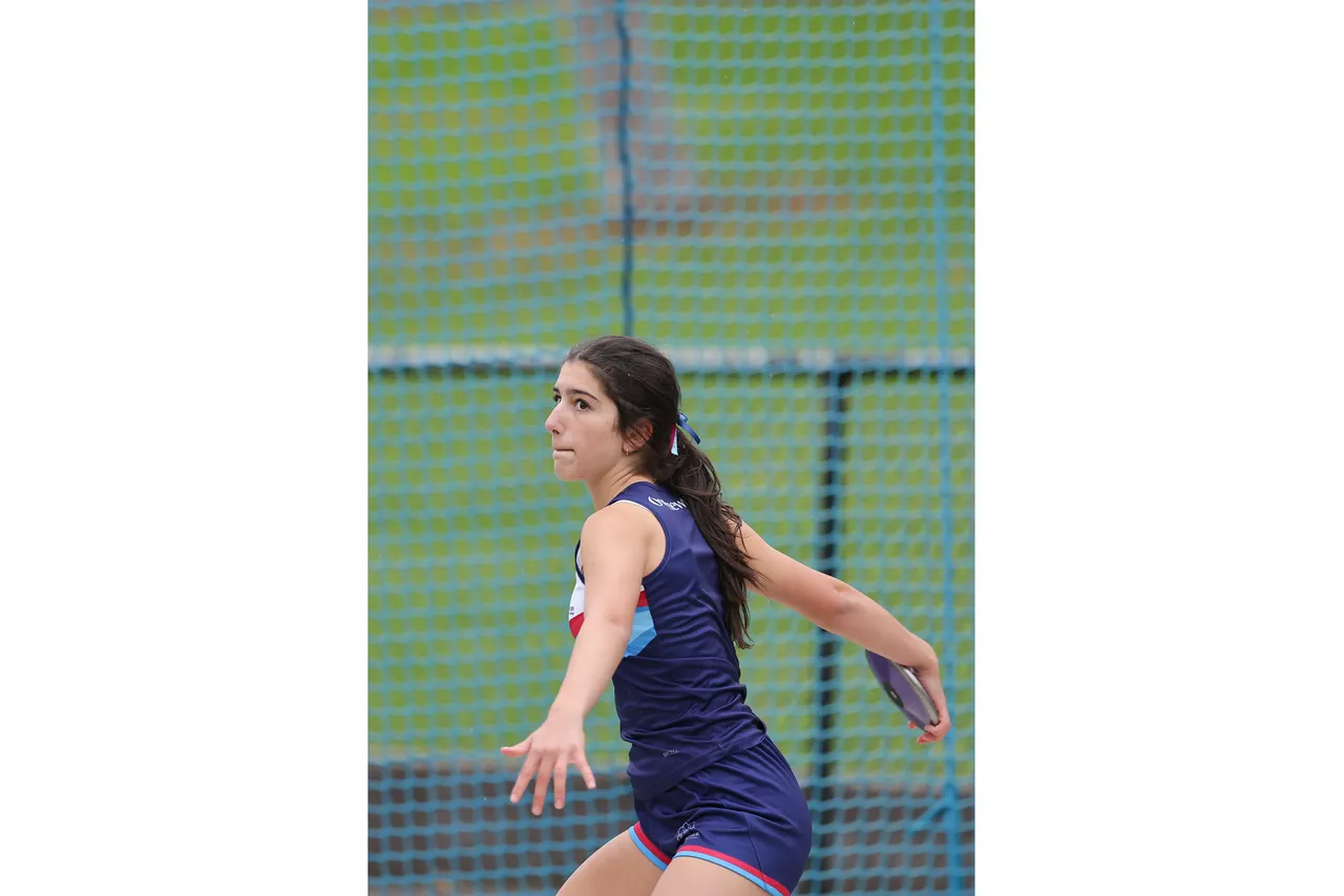 Action shot of upper secondary school aged student competing in the discus event at the 2026 ACS Athletics Championship.