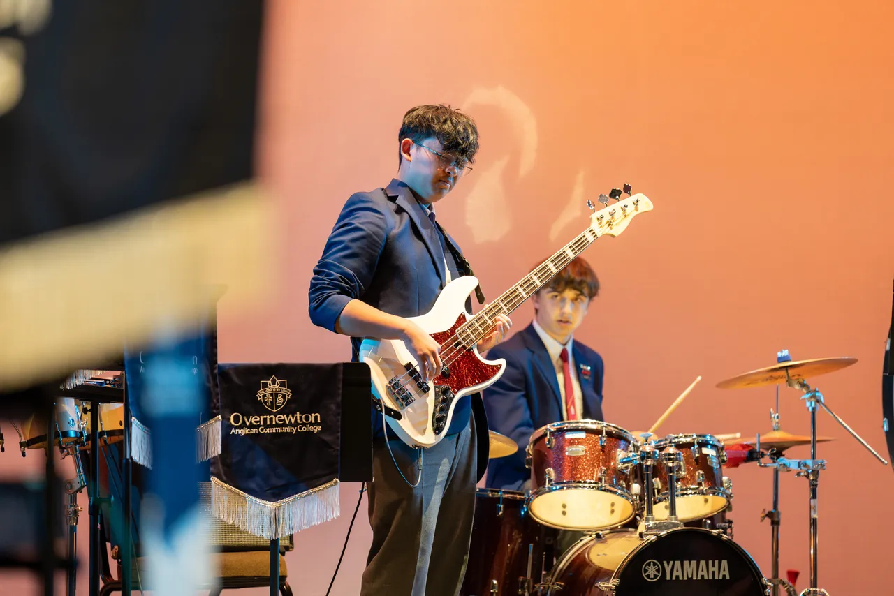 Upper secondary school aged Performing Arts students performing on guitar and drums as part of Overnewton's Jazz Band at Overnewton's Annual Come Together 2026 concert held at the Clocktower Centre, Moonee Ponds.