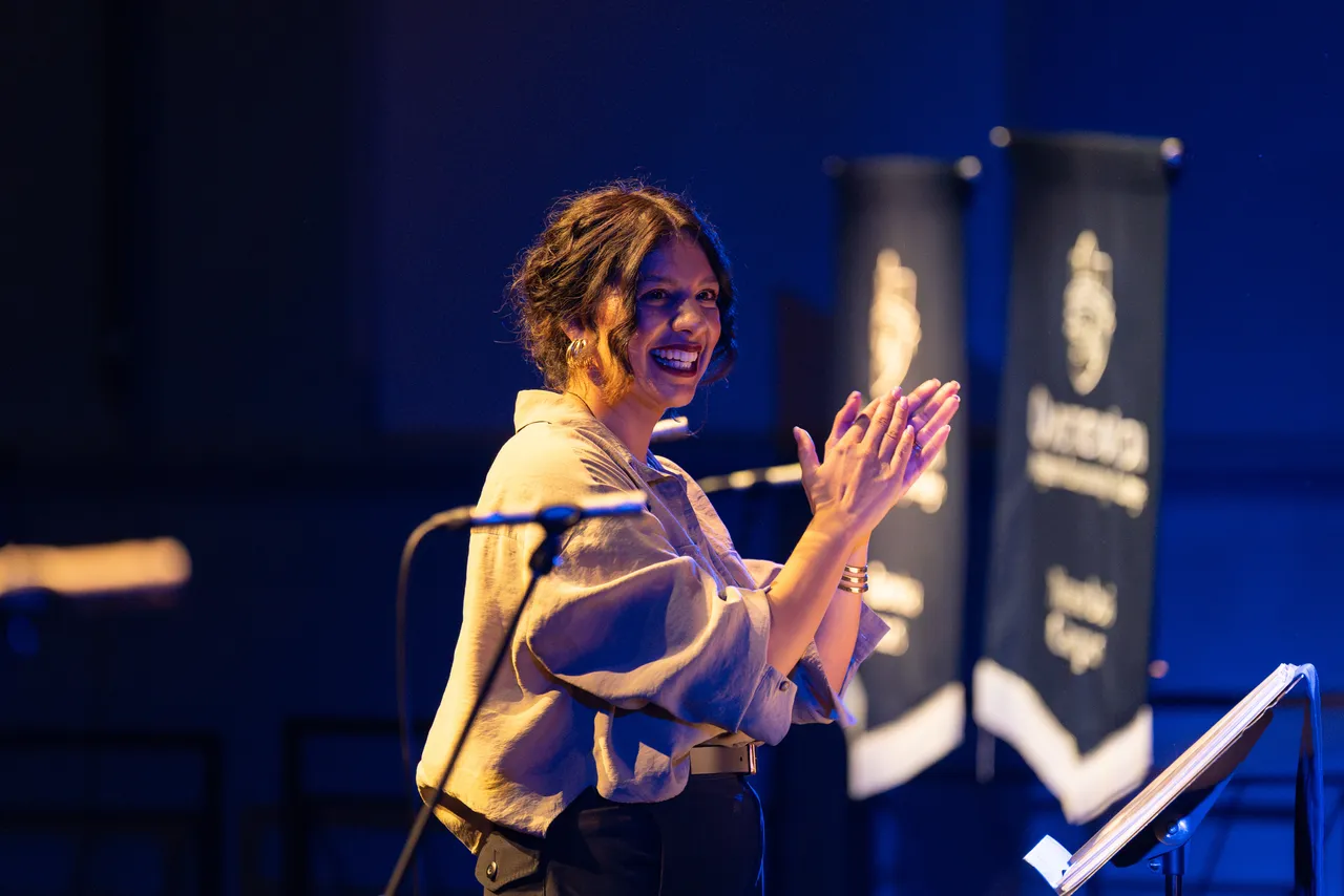Performing Arts teacher of Voice, Natasha Mateus, joyously conducting the Senior Choir at Overnewton's Annual Come Together 2026 concert held at the Clocktower Centre, Moonee Ponds.