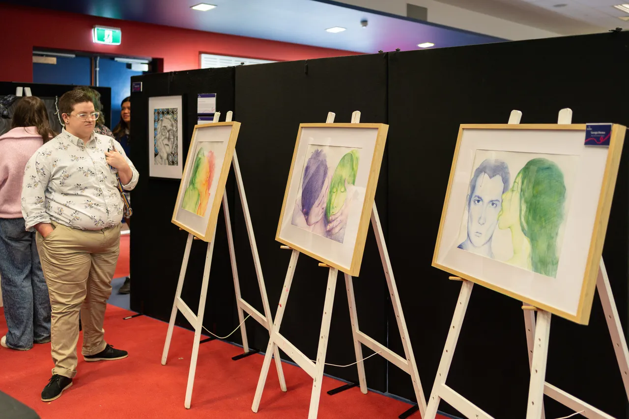A guest at Overnewton's Annual Visual Arts & Technologies Exhibition viewing the artworks of Senior School Visual Arts students.