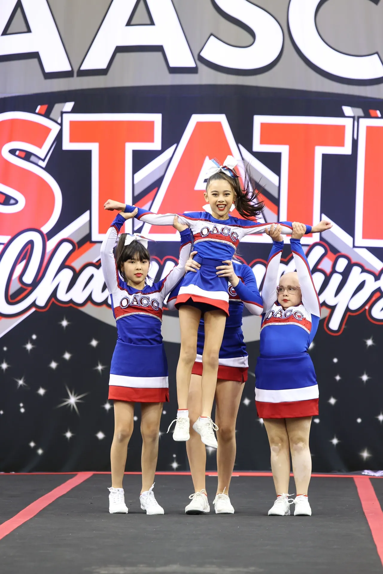 Lower secondary school aged students from Overnewton's Middle School Cheer team performing part of their prize-winning routine at the 2025 AASCF State Championships.