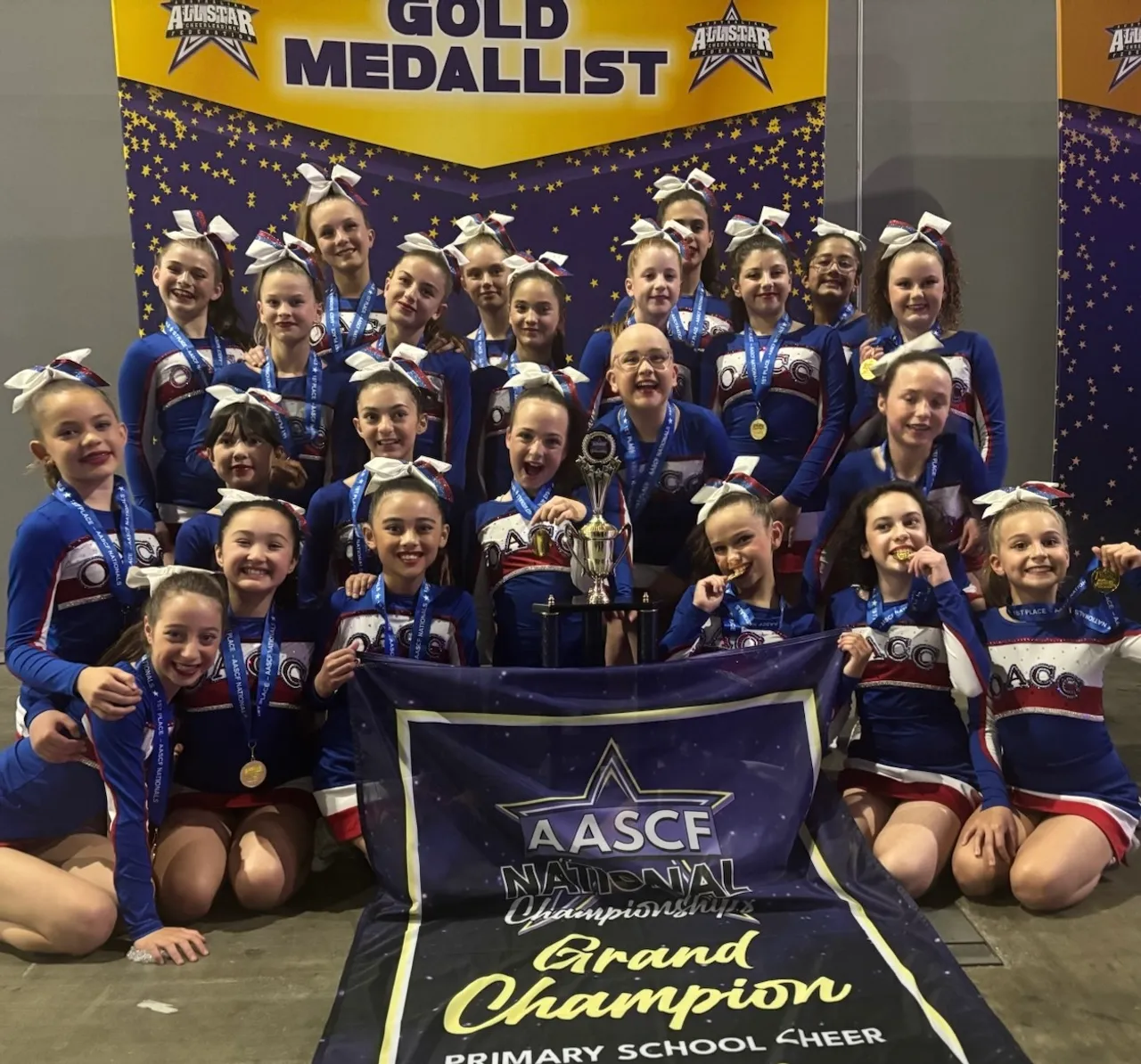 Overnewton Cheer team, the Angels, celebrating their Gold Medal win in the Primary School Division and Grand Champion crown at the 2025 AASCF All Star Nationals in Melbourne.