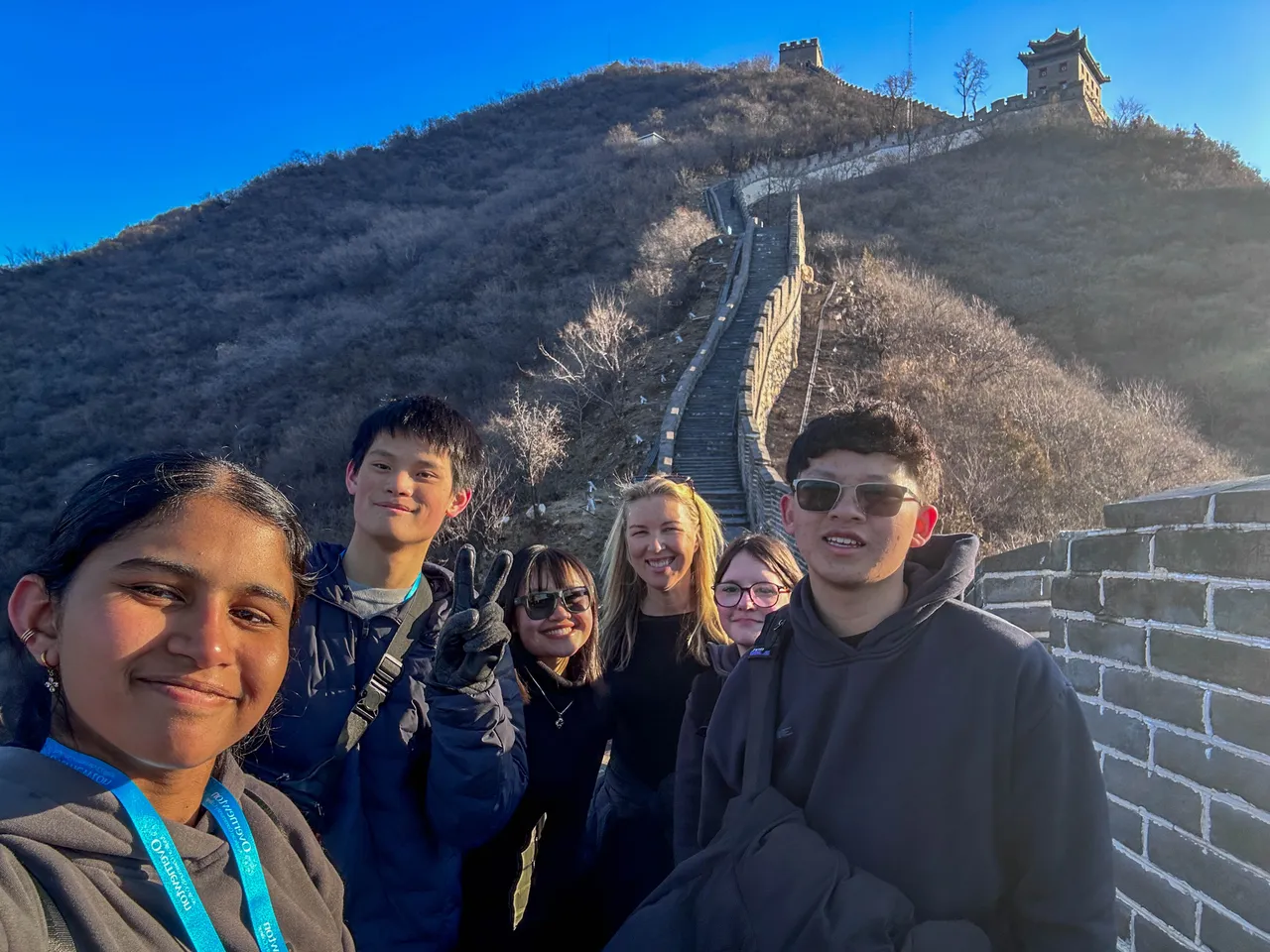 Middle and upper secondary school aged students and a staff member standing together on the Great Wall of China during Overnewton’s 2025 China Tour.