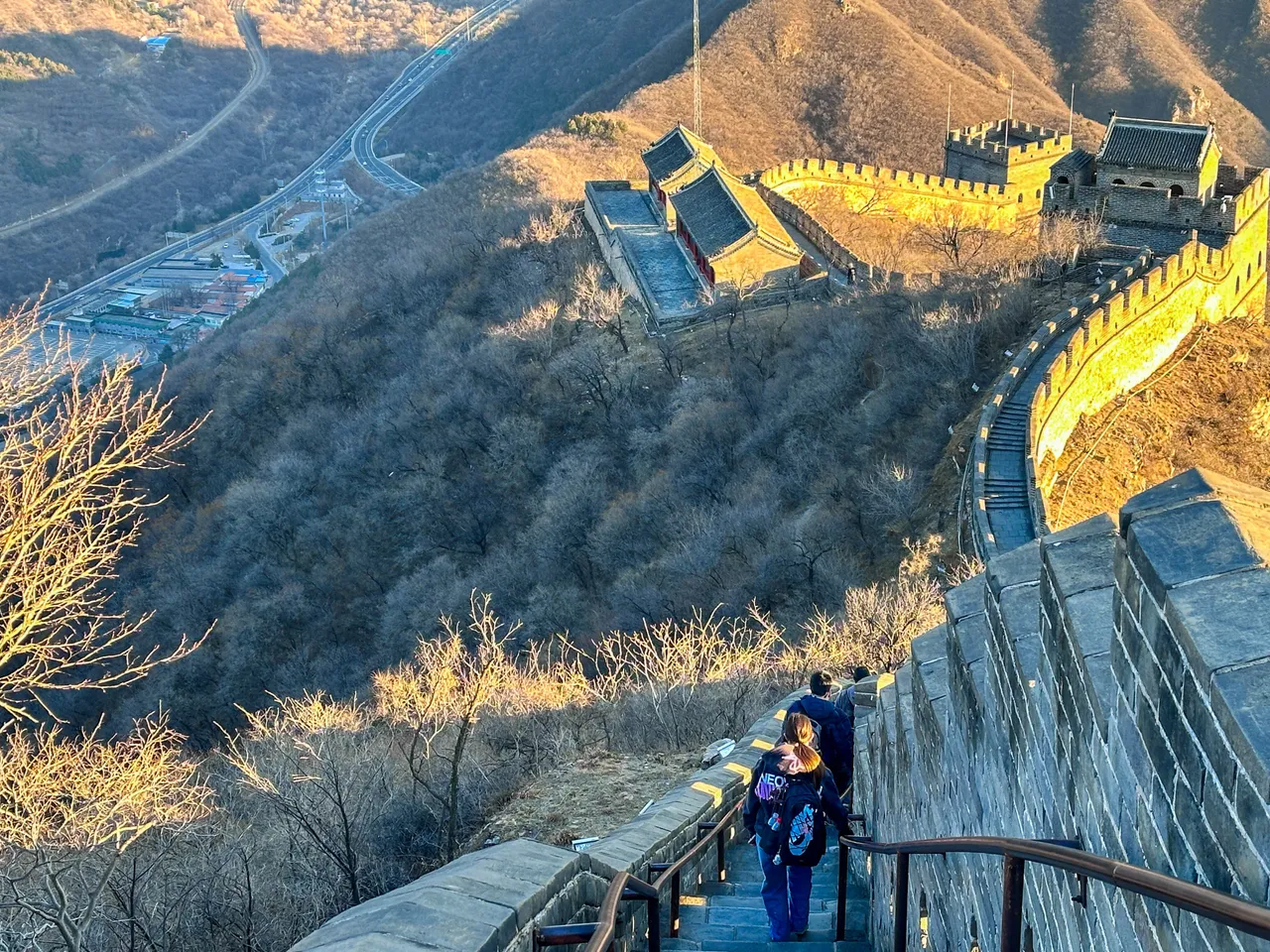Students and staff walking single file down a steep section of the Great Wall of China during Overnewton’s 2025 China Tour.